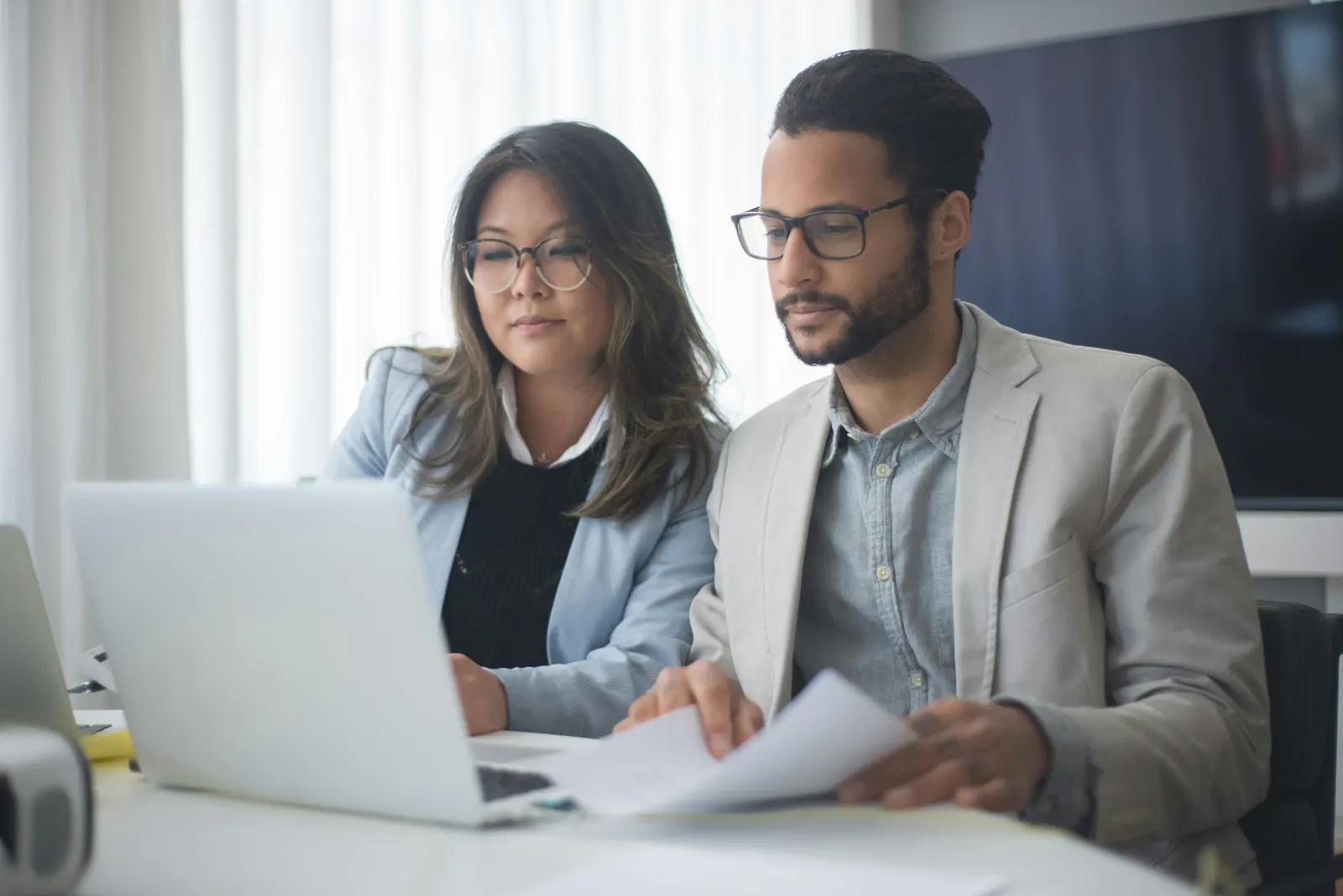 Two Totus One advisers reviewing a client's position together
