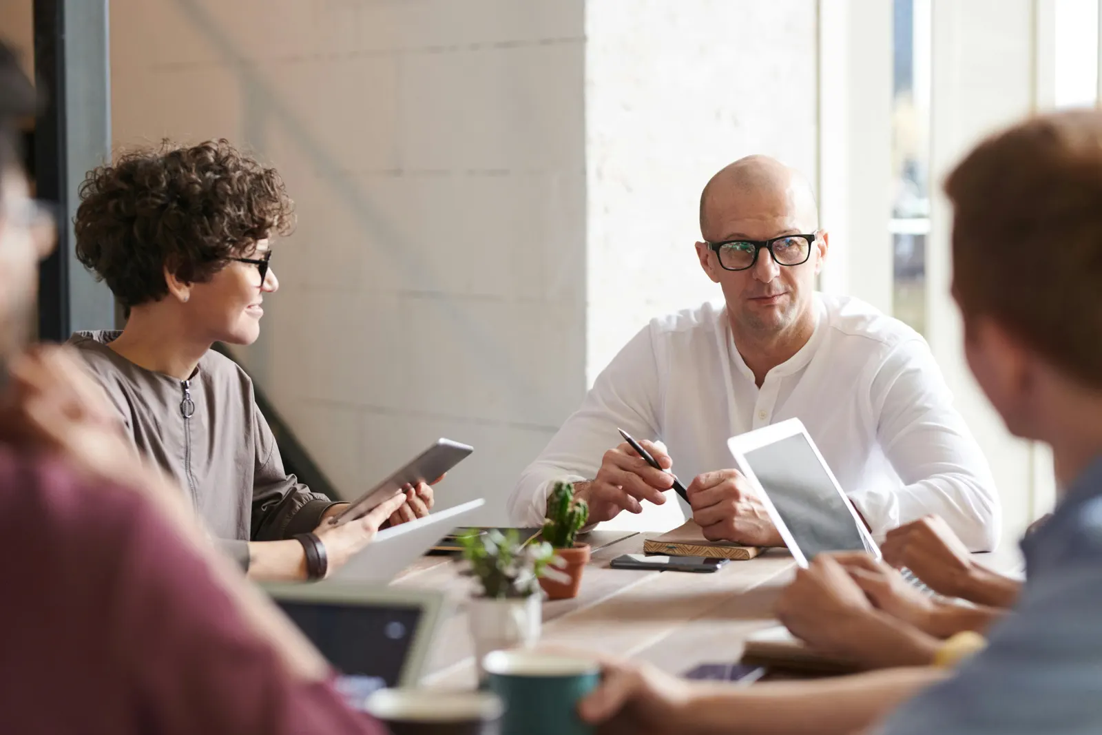 A Totus One team meeting around the table