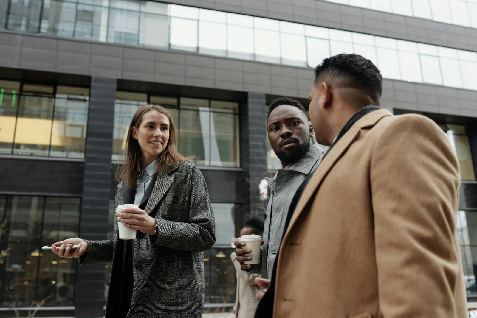 Three professionals in conversation on a London street