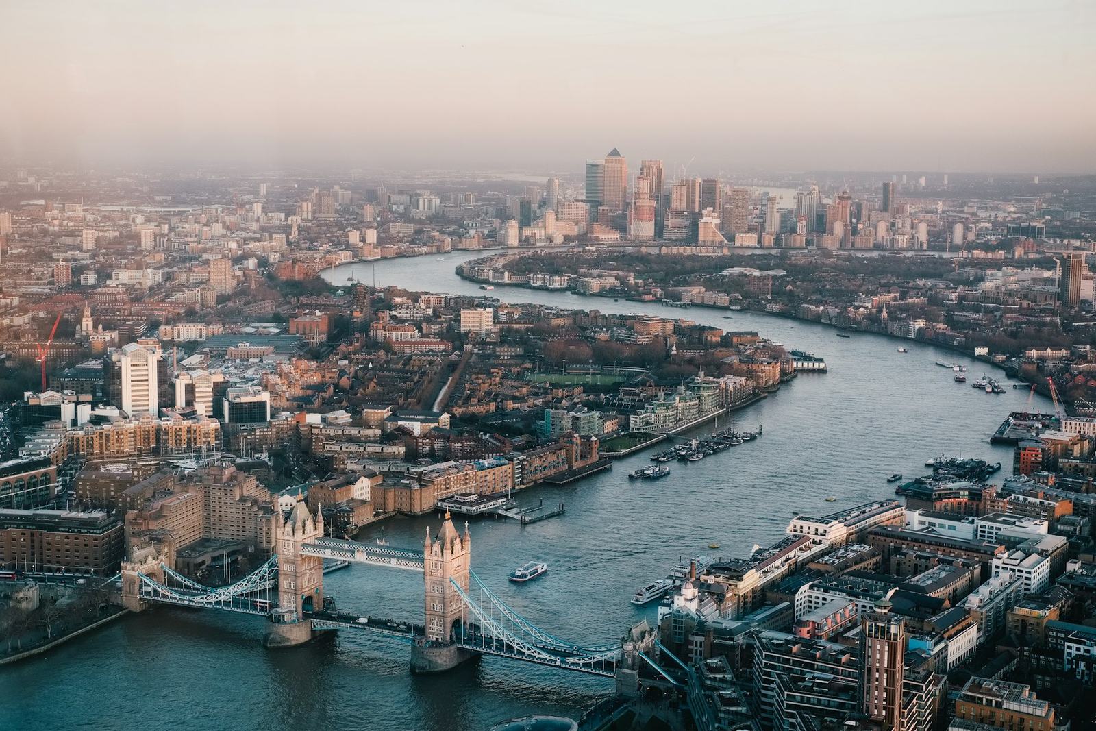 Aerial view of the City of London, the River Thames and Tower Bridge at dusk